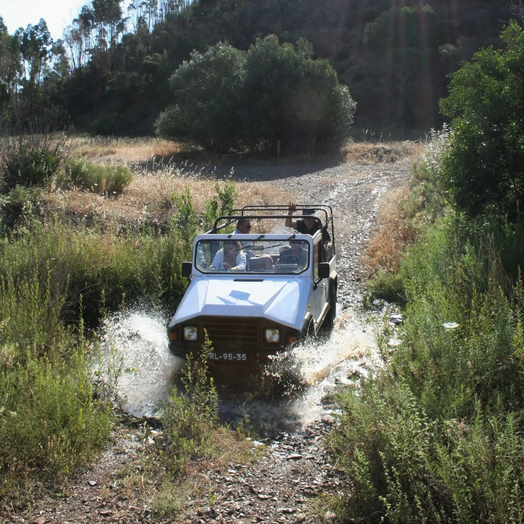 Open jeep crossing water on a Silves hills route