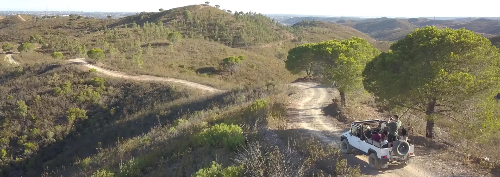 White open jeep on a dirt road through the Silves hills